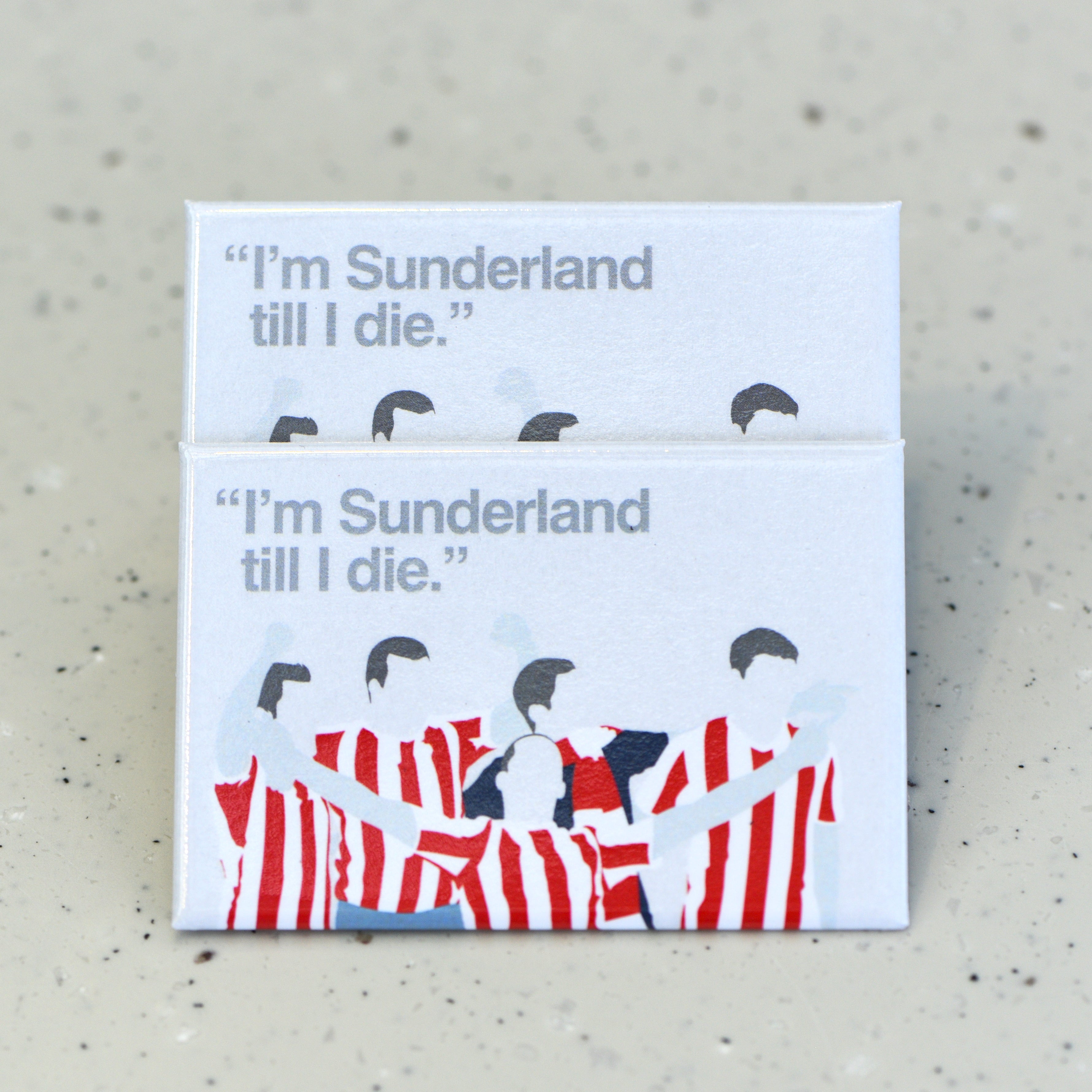 Two flat rectangle magnets sit one on top of the other - they feature a graphic illustration of four faceless figures wearing red and white striped t-shirts with raised arms, a fifth figure in the front has its arms spread wide in celebration. In grey text, to the top left of the magnet, reads "I'm Sunderland till I die."