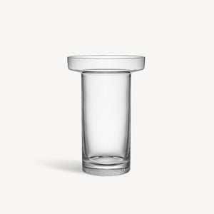 A clear glass vase with a tall cylinder shape that widens into a wide flat cylinder at the top, sat against a white background.
