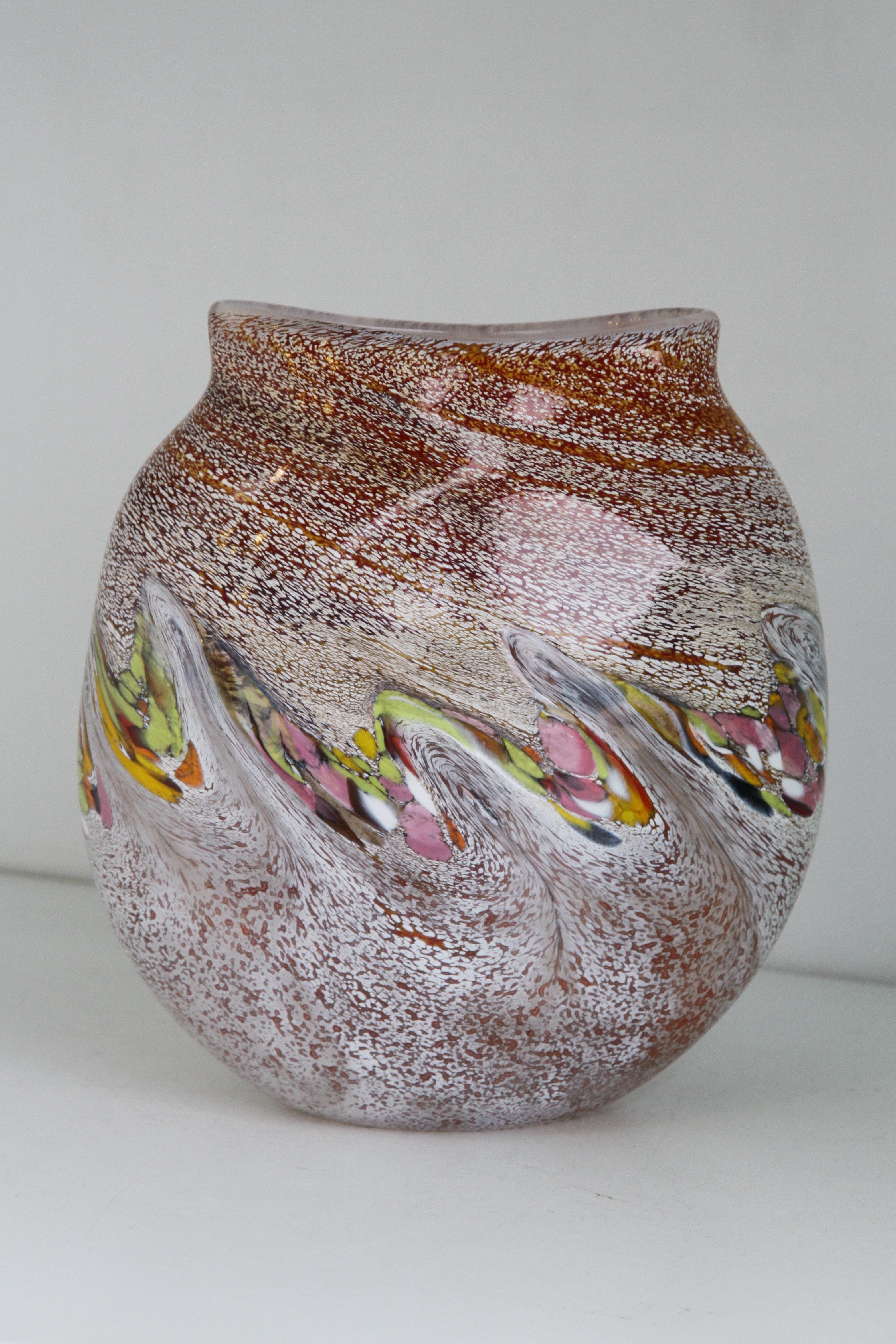 Cream, orange, brown vase with yellow, green and purple detail